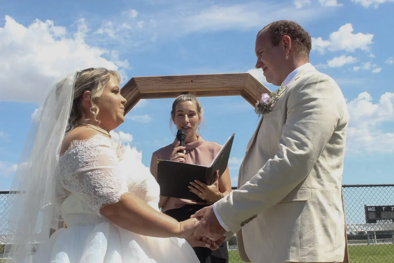 Aerial view of wedding guests forming a circle around the couple