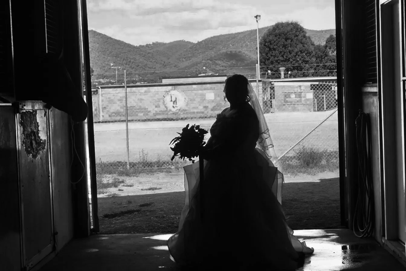 Bride silhouette with bouquet in a doorway